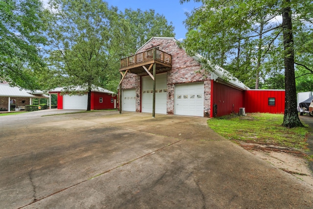 view of home's exterior with a garage, concrete driveway, and brick siding