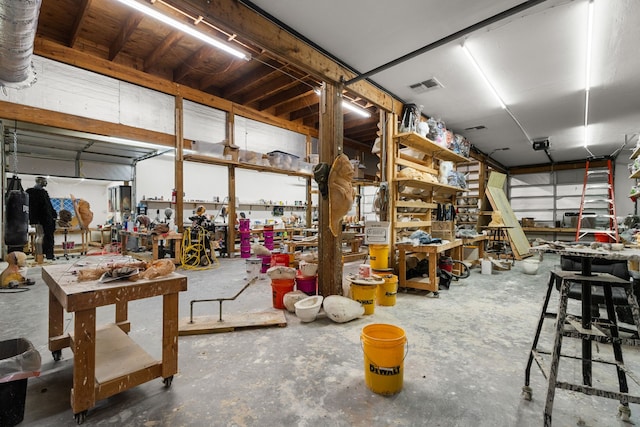 garage with a workshop area and visible vents