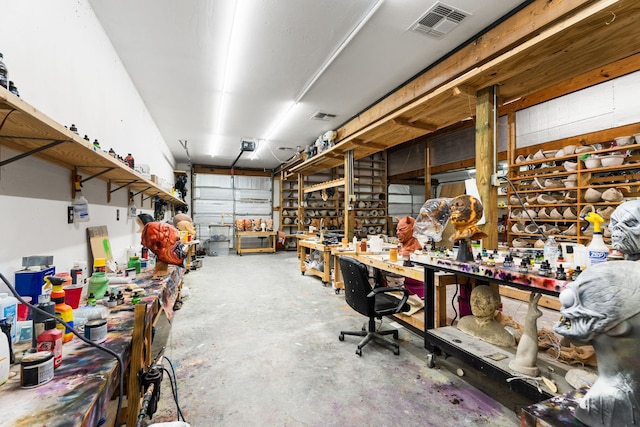 garage with a workshop area and visible vents