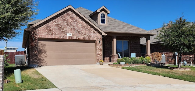 view of front of property with roof with shingles, brick siding, a garage, central air condition unit, and driveway