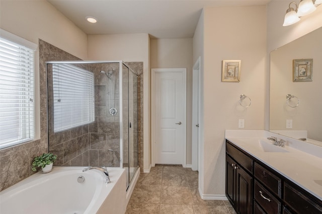 full bathroom with double vanity, a sink, a garden tub, and a shower stall