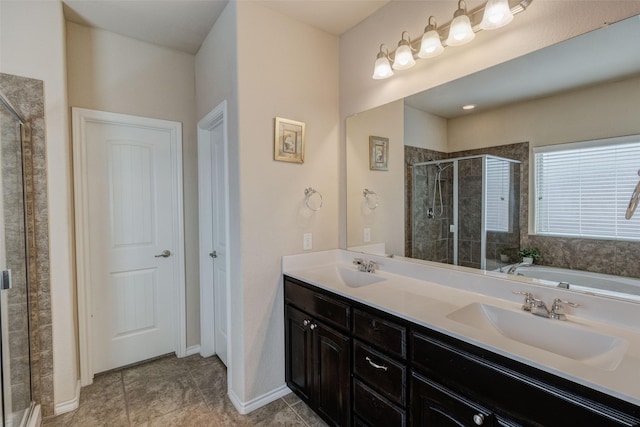 bathroom with double vanity, tile patterned floors, a shower stall, and a sink