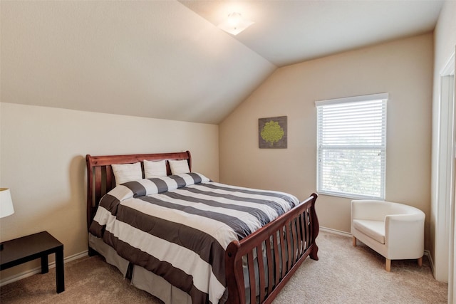 carpeted bedroom with baseboards and lofted ceiling