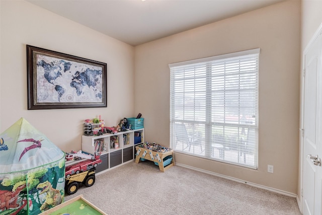 recreation room with plenty of natural light, carpet flooring, and baseboards