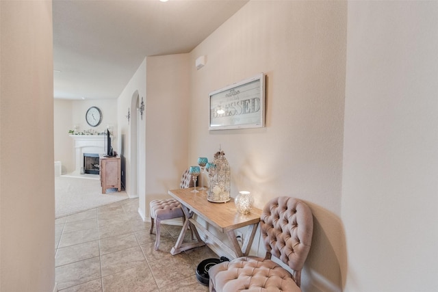 hallway featuring light carpet and light tile patterned floors