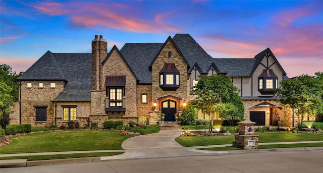 1237 Wales Dr, Mclendon Chisholm, TX 75032 - view of front of home with a front lawn, a chimney, stucco siding, and stone siding