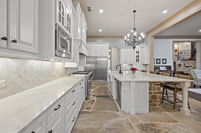 1237 Wales Dr, Mclendon Chisholm, TX 75032 - kitchen featuring stone flooring, built in appliances, crown molding, a kitchen bar, and decorative backsplash