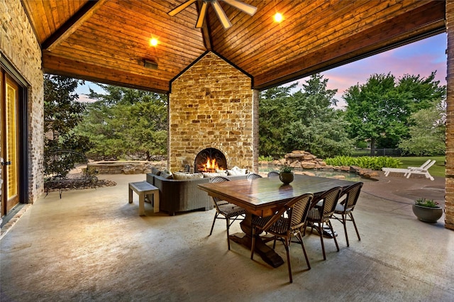1237 Wales Dr, Mclendon Chisholm, TX 75032 - patio terrace at dusk featuring an outdoor brick fireplace, a patio, outdoor dining space, and a ceiling fan