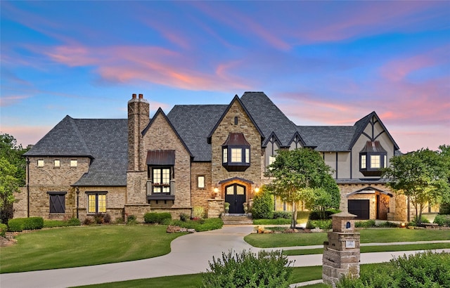 1237 Wales Dr, Mclendon Chisholm, TX 75032 - view of front of home featuring a lawn, stone siding, a chimney, and curved driveway