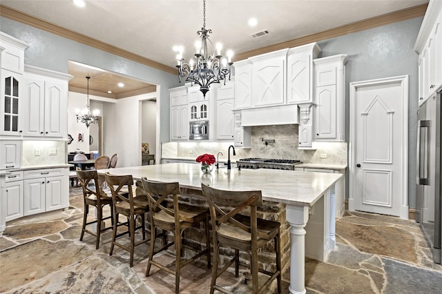1237 Wales Dr, Mclendon Chisholm, TX 75032 - kitchen with a chandelier, stone floors, crown molding, tasteful backsplash, and white cabinetry