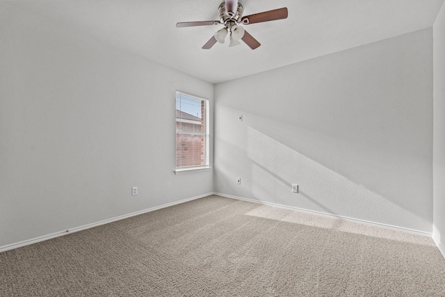 spare room featuring carpet floors, ceiling fan, and baseboards
