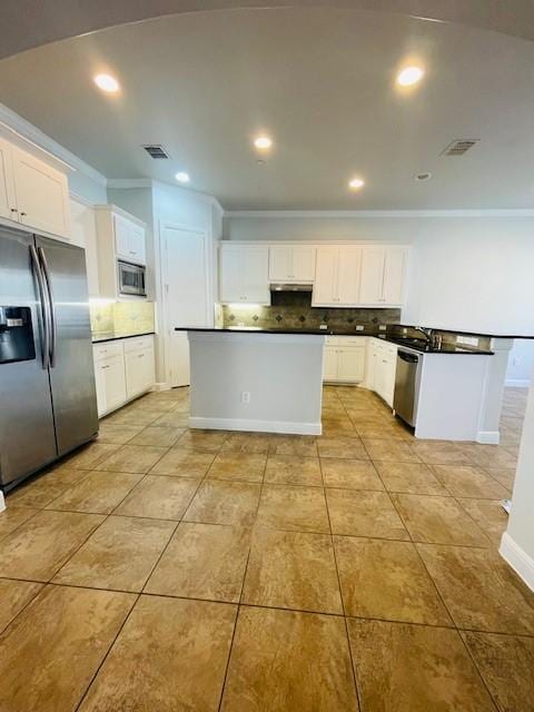 kitchen featuring dark countertops, tasteful backsplash, and stainless steel appliances