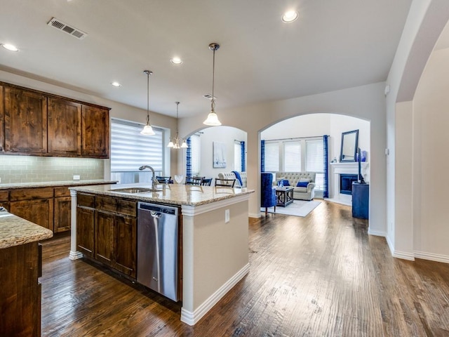 5517 Grove Cove Dr, Mckinney, TX 75071 - kitchen with visible vents, light stone countertops, dark wood-type flooring, a sink, and dishwasher