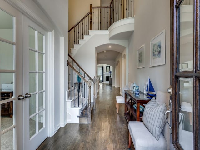 5517 Grove Cove Dr, Mckinney, TX 75071 - foyer with french doors, dark wood-style flooring, arched walkways, stairway, and a high ceiling