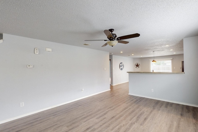 spare room with visible vents, wood finished floors, ceiling fan, recessed lighting, and a textured ceiling