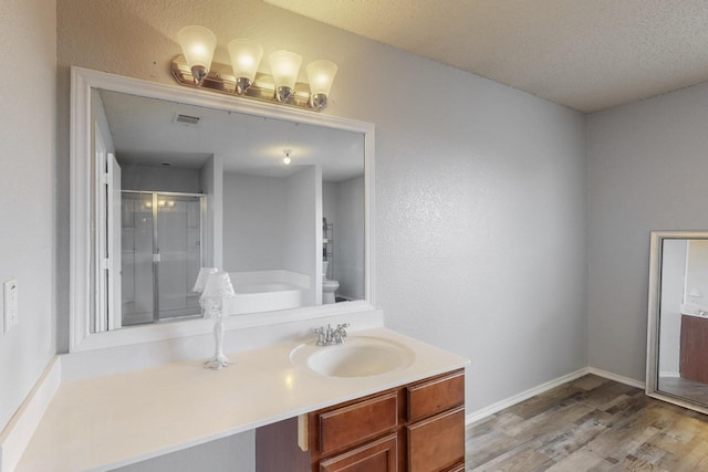 bathroom featuring visible vents, a shower stall, wood finished floors, baseboards, and toilet