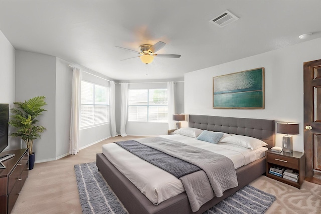bedroom with baseboards, a ceiling fan, and visible vents