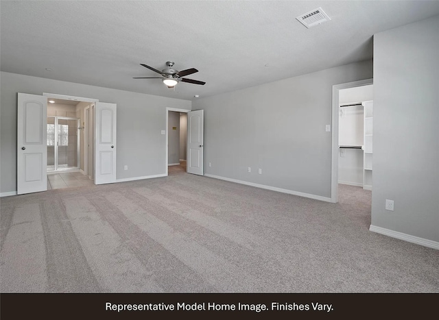 unfurnished bedroom featuring visible vents, baseboards, and carpet floors