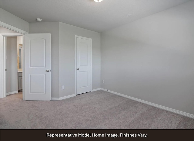 unfurnished bedroom with baseboards and light carpet
