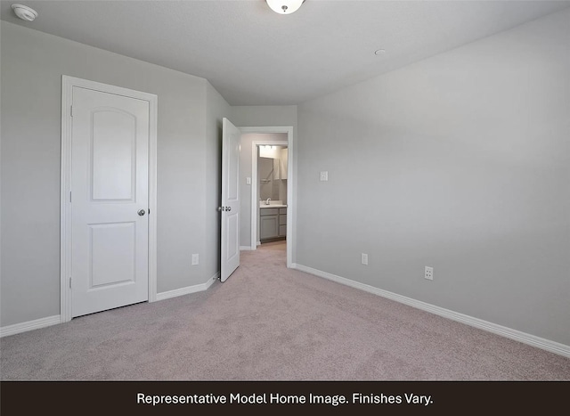 unfurnished bedroom with baseboards and light colored carpet