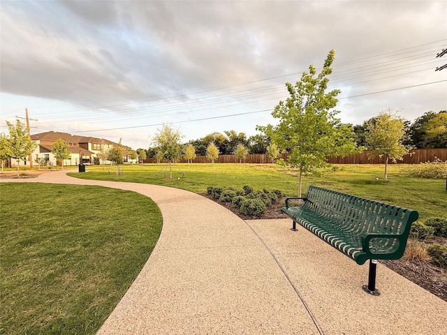 view of home's community featuring fence and a yard