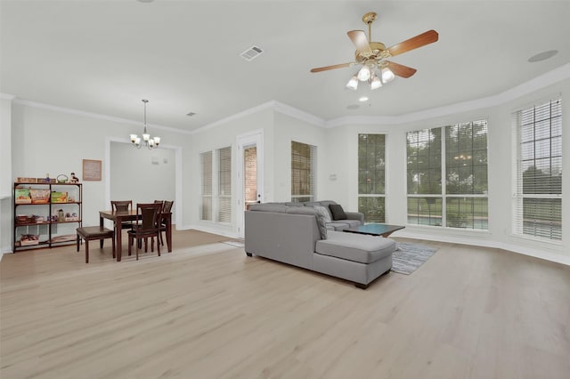 living area with healthy amount of natural light, light wood finished floors, a chandelier, and ornamental molding