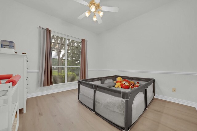 bedroom with wood finished floors, baseboards, and a ceiling fan