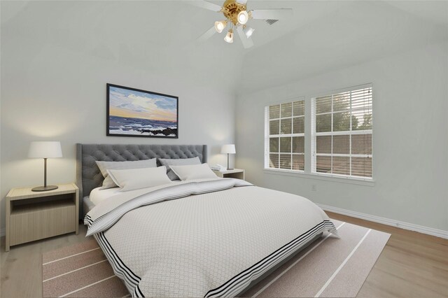 bedroom featuring light wood-type flooring, baseboards, and ceiling fan