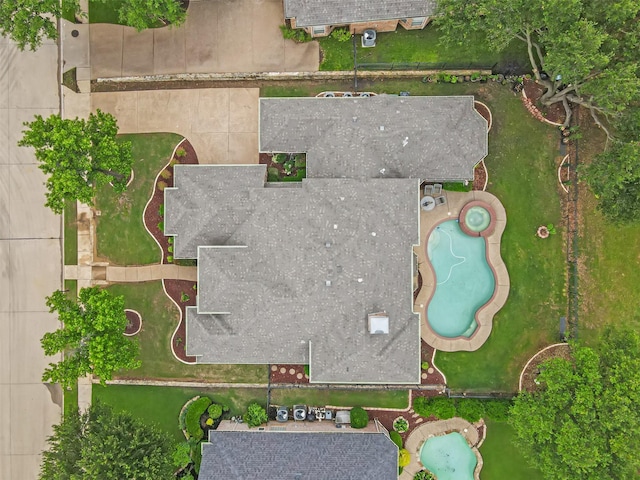 aerial view of property and surrounding area featuring a pool