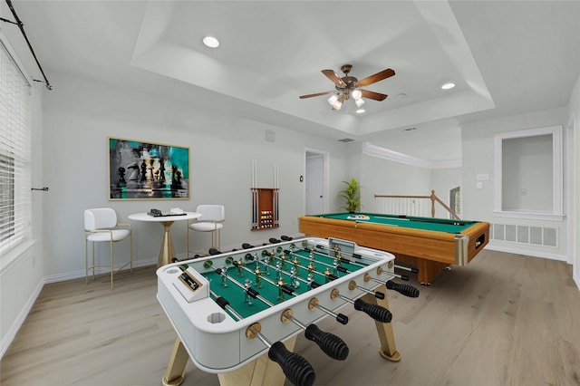 playroom featuring a tray ceiling, light wood finished floors, a ceiling fan, billiards, and recessed lighting