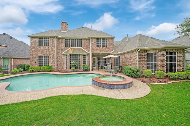 view of pool with a patio area and a pool with connected hot tub