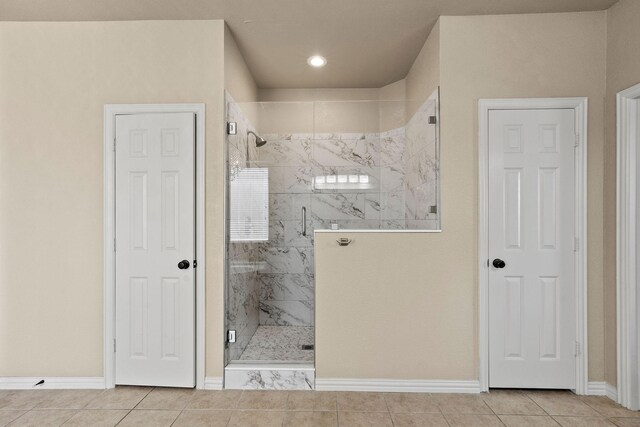 1185 Shores Blvd, Rockwall, TX 75087 - bathroom featuring baseboards, a marble finish shower, and tile patterned floors