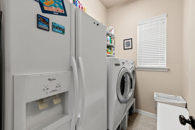 1185 Shores Blvd, Rockwall, TX 75087 - clothes washing area with baseboards, laundry area, washing machine and dryer, and light tile patterned flooring