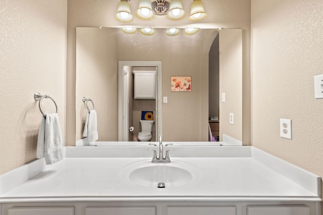 1185 Shores Blvd, Rockwall, TX 75087 - bathroom with vanity, a textured wall, and toilet