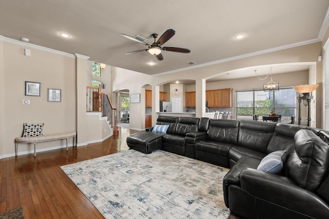 1185 Shores Blvd, Rockwall, TX 75087 - living room with ornamental molding, baseboards, arched walkways, dark wood finished floors, and ceiling fan with notable chandelier