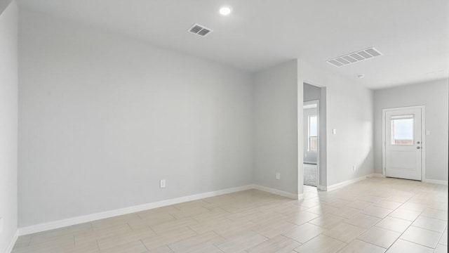 empty room featuring visible vents and baseboards