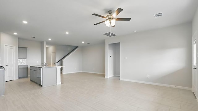 unfurnished living room with recessed lighting, ceiling fan, visible vents, and baseboards