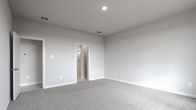 unfurnished bedroom featuring baseboards, carpet flooring, recessed lighting, and visible vents
