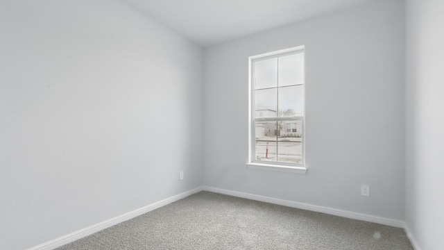 empty room with carpet floors and baseboards