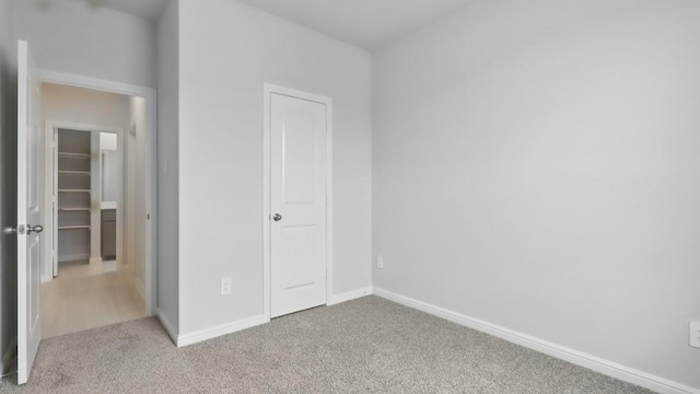 unfurnished bedroom featuring carpet floors and baseboards
