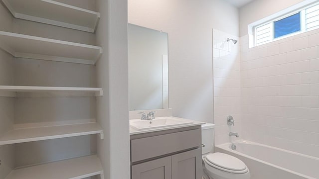 bathroom with vanity, toilet, and bathtub / shower combination