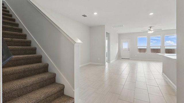 entryway with stairs, ceiling fan, and visible vents