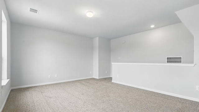empty room with visible vents, baseboards, and carpet floors