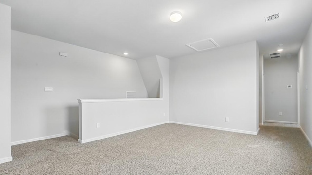 carpeted empty room with visible vents, attic access, baseboards, and recessed lighting