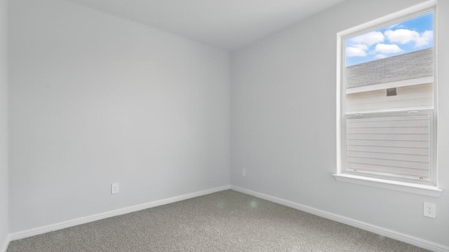 spare room with baseboards