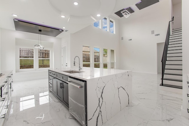 kitchen with visible vents, hanging light fixtures, stainless steel dishwasher, a sink, and marble finish floor