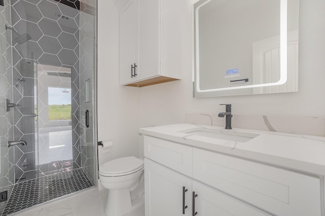 bathroom featuring toilet, a shower stall, marble finish floor, and vanity