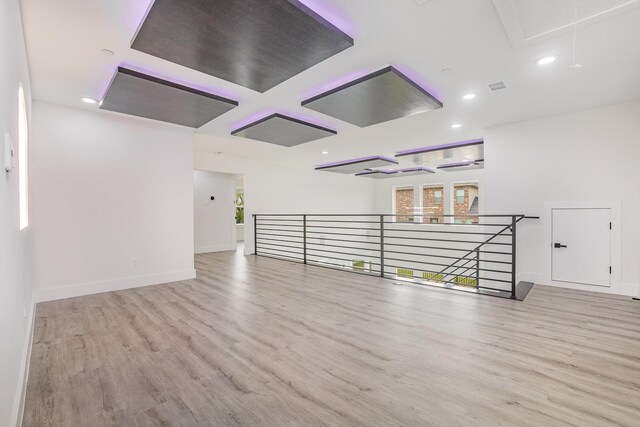 unfurnished room featuring visible vents, wood finished floors, baseboards, attic access, and recessed lighting
