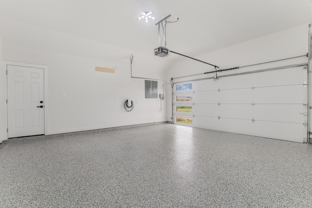 garage with a garage door opener and electric panel