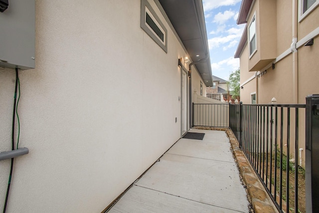 view of property exterior with stucco siding and fence